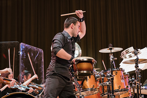 Musician performing with percussion group live on stage