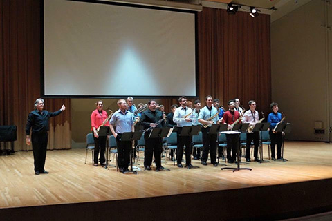 Members of the saxophone band pose for a picture on stage