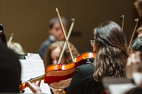 Violinist plays during an event at the University of Miami